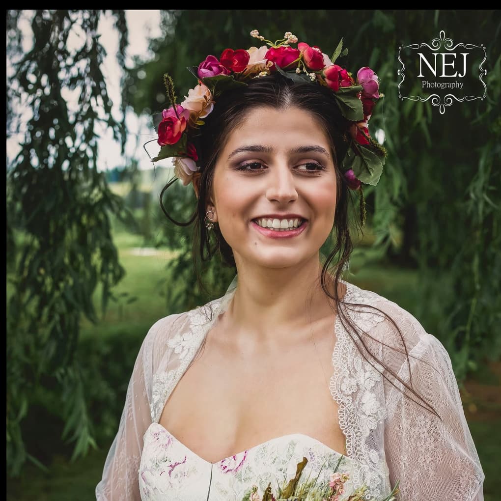 A woman smiling in a bridal outfit