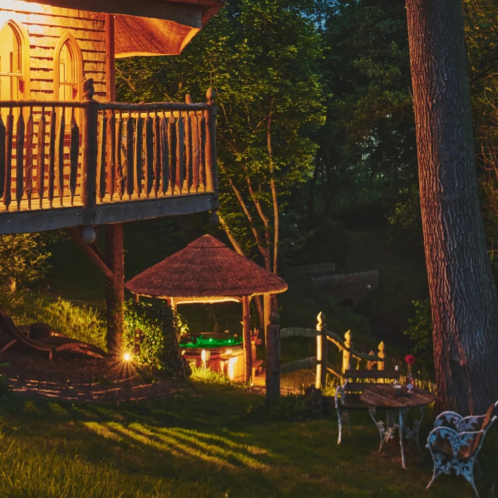 Eathelin's hot tub area and wrap around balcony with lit up canopy. 