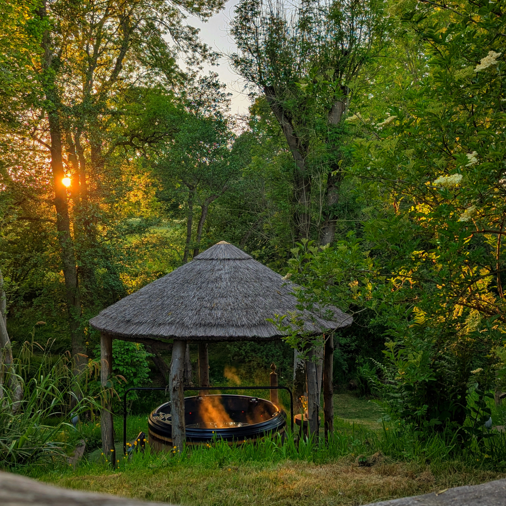 Eathelin exterior view and hot tub at dusk with the canopy lit