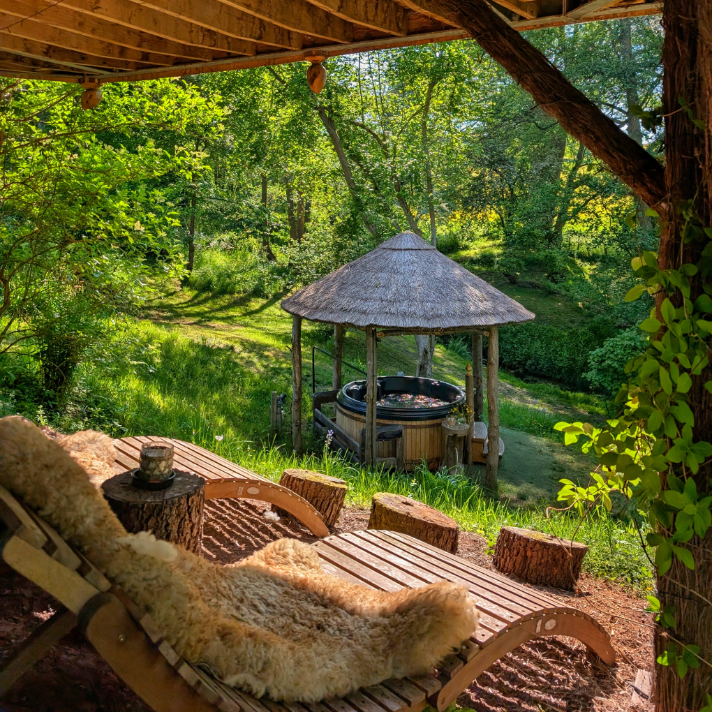 Eathelin's hot tub area and wrap around balcony with lit up canopy. 